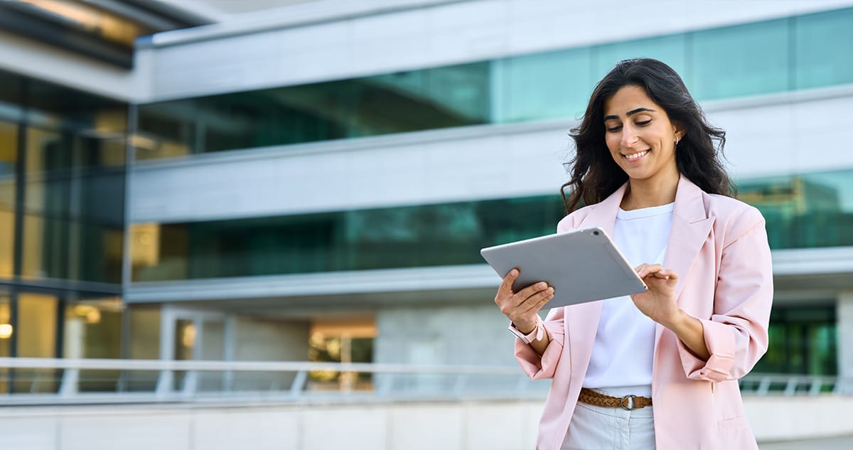 ABFSecurity-Blog082025-3 People looking at tablet. Tablet is enlarged to show commercial security solutions