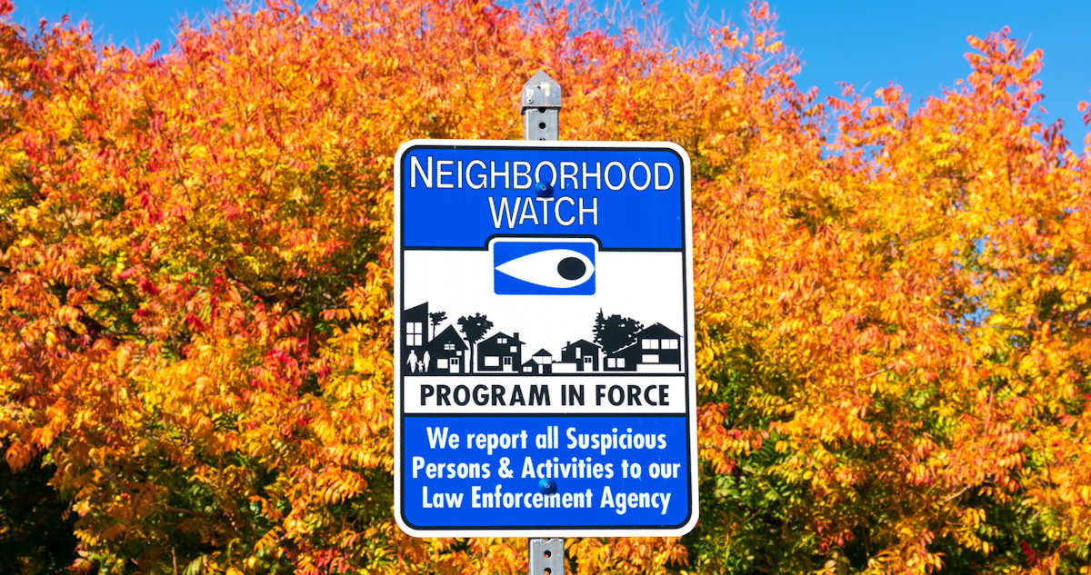 People looking at tablet. Tablet is enlarged to show commercial security solutions