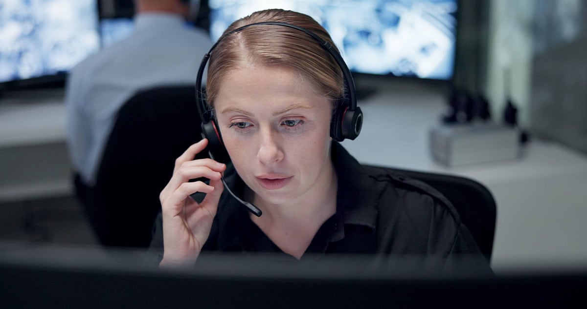 People looking at tablet. Tablet is enlarged to show commercial security solutions