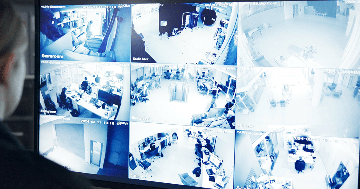 People looking at tablet. Tablet is enlarged to show commercial security solutions