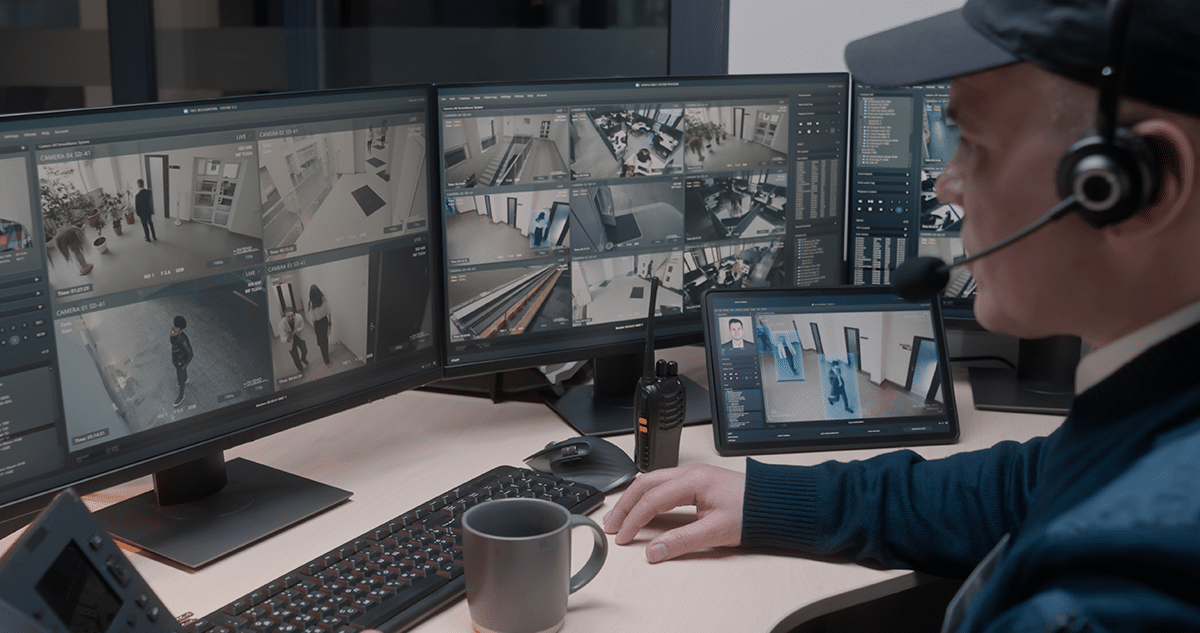 People looking at tablet. Tablet is enlarged to show commercial security solutions